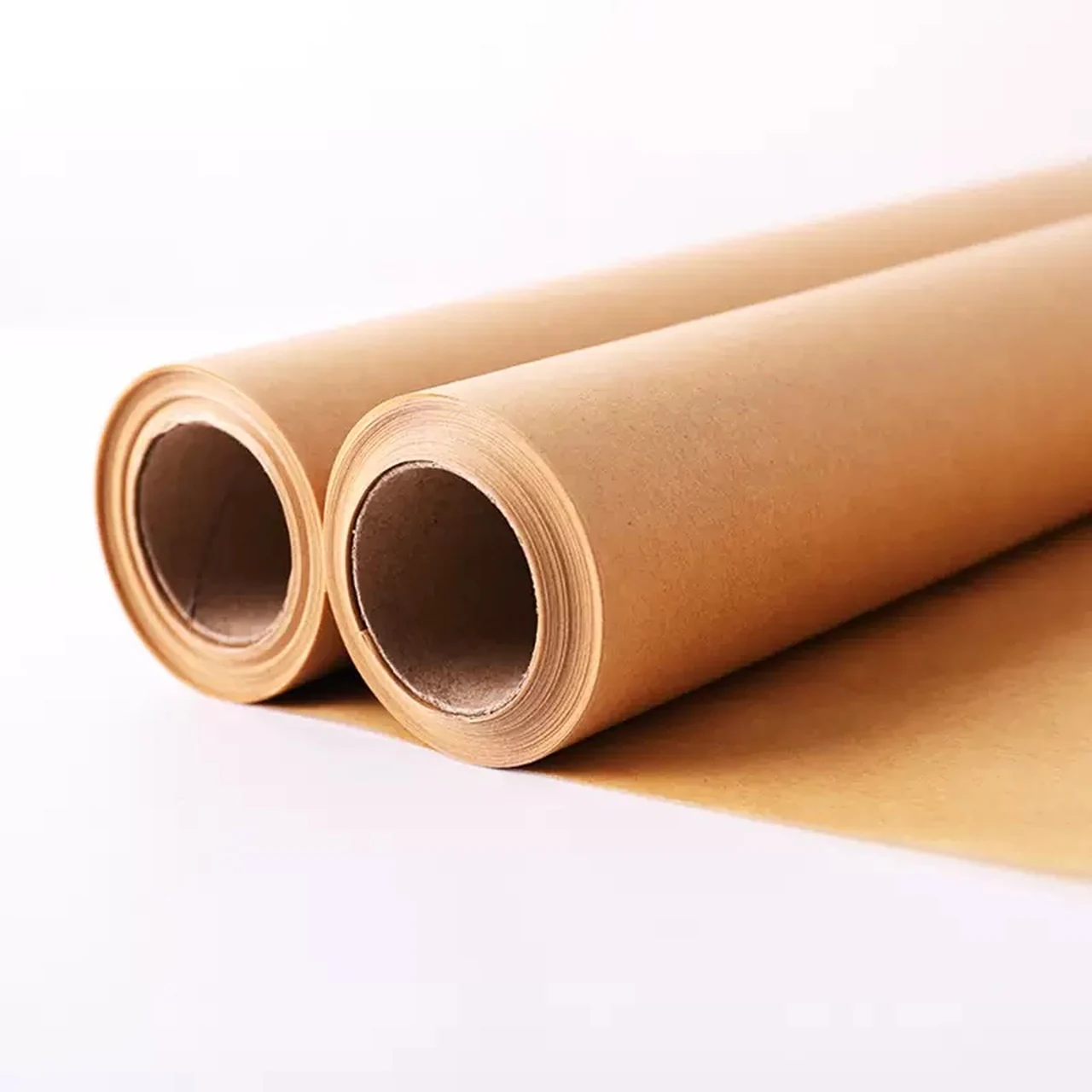 Two natural-color baking paper rolls partly unrolled.