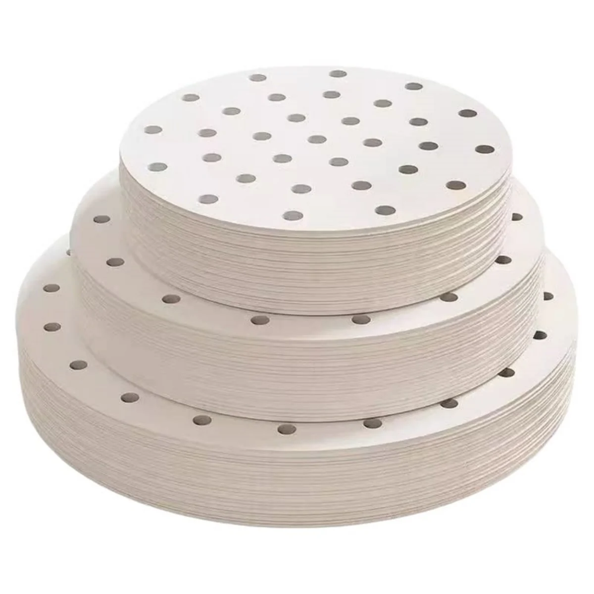 Stacks of white round perforated steamer paper in several sizes.