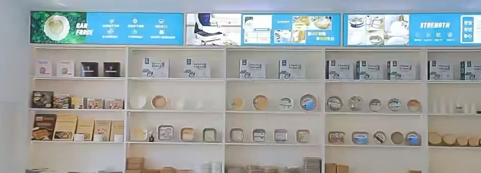 Paper products and retail packs displayed on shelves in the company showroom.
