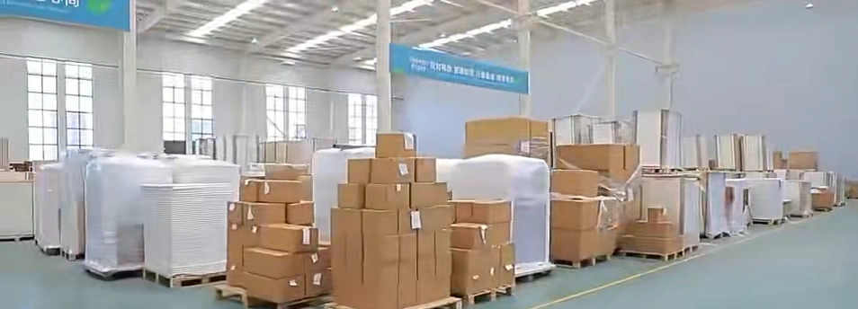 Wrapped paper stock and cartons on pallets in the factory warehouse.