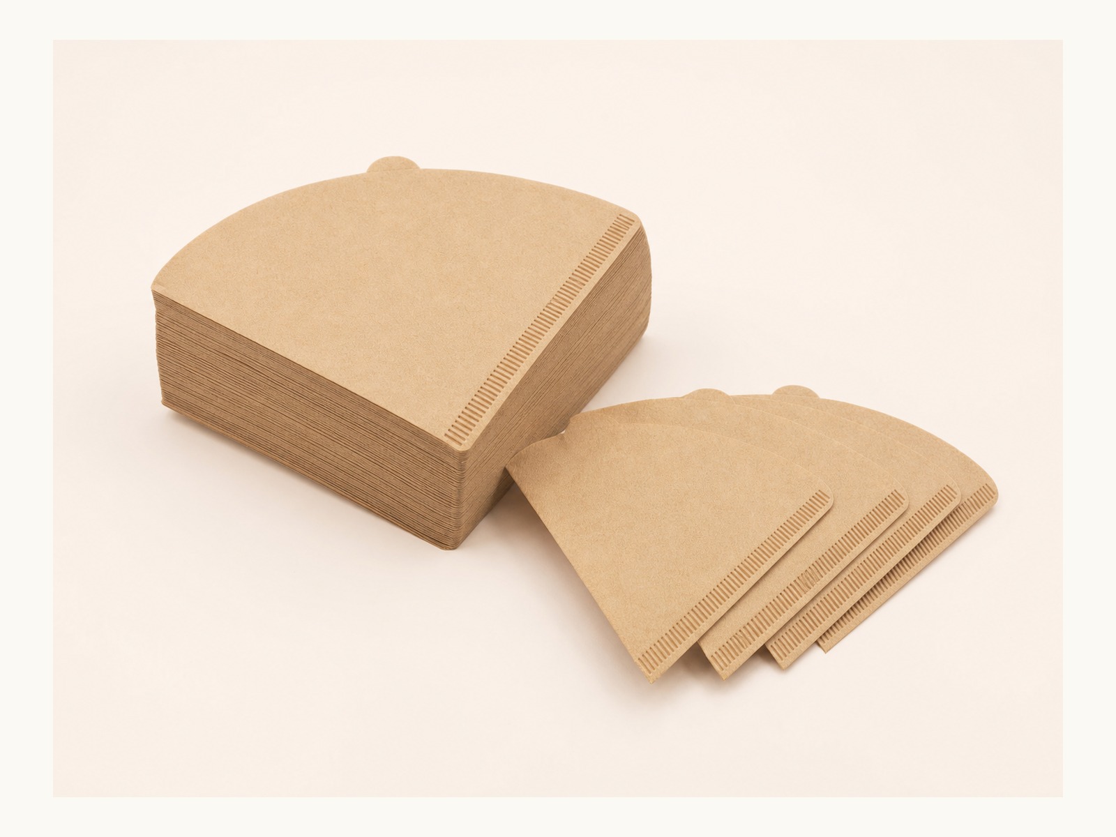 Complete natural V60 cone coffee filter paper stack with loose filter papers